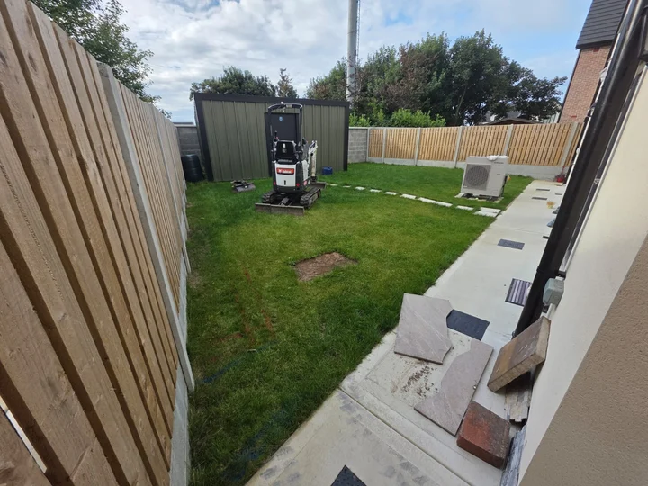The original lawn and narrow path before the porcelain patio installation.