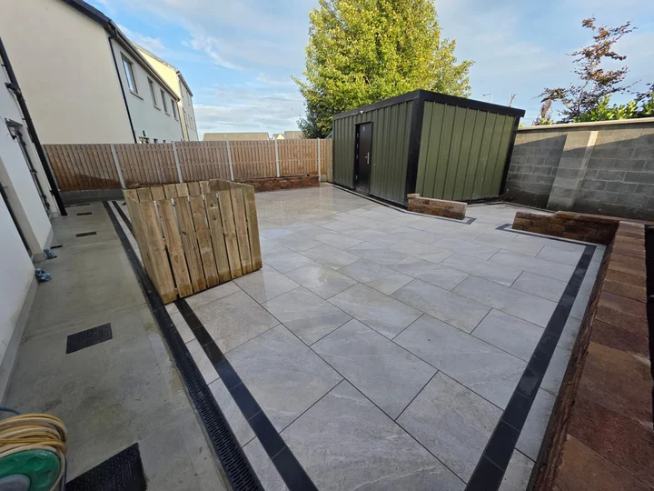 Porcelain patio, dark border and raised beds in Haggardstown