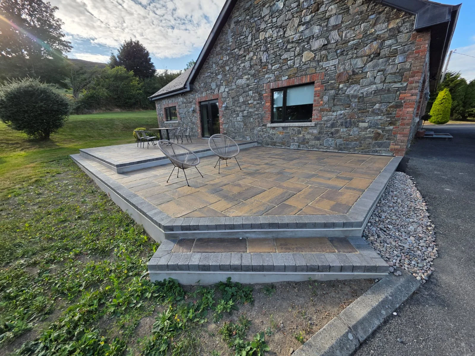 A finished stone terrace with broad steps beside a County Louth home