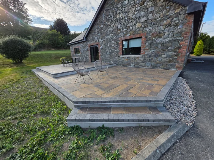 A finished stone terrace with broad steps beside a County Louth home