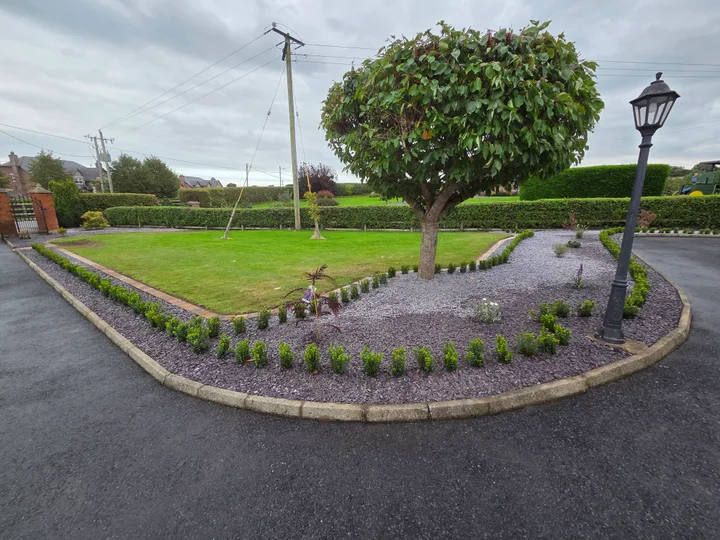 Lawn, curved paving and planted borders in Louth Village