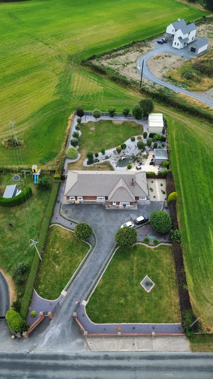 An aerial view of the house, entrance and rear garden.