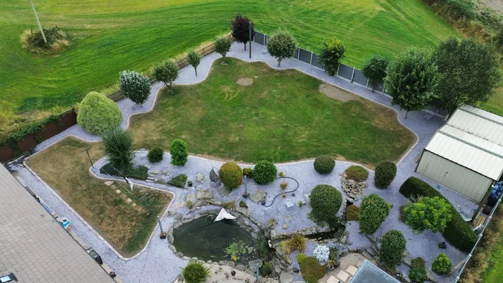 Curving lawn edges and paths around the planted garden.