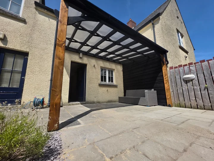 The roof framing and side screen above the patio.